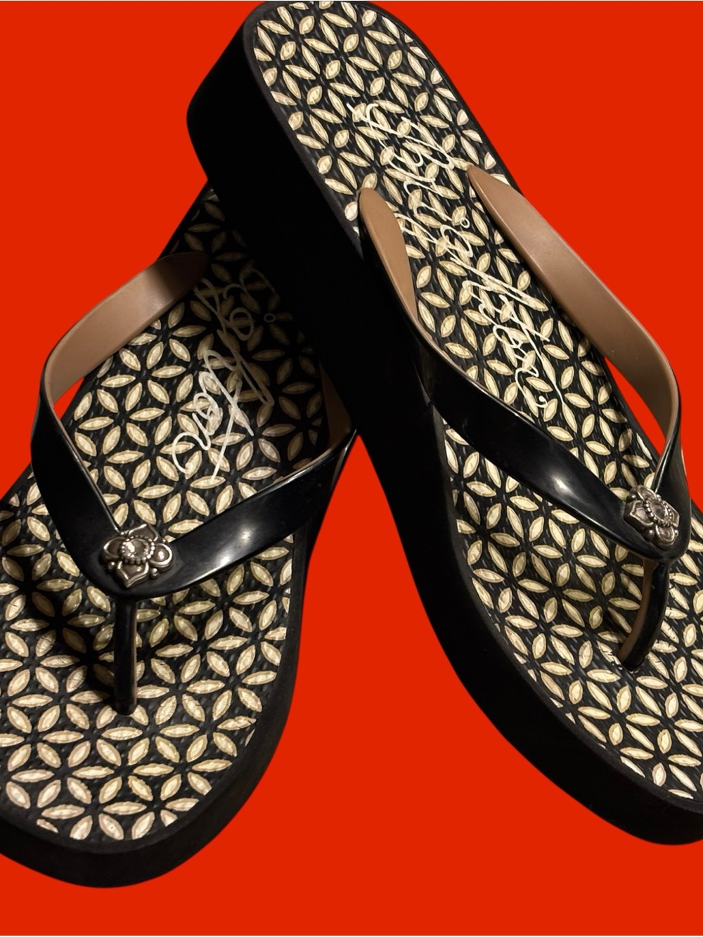 Brighton Black and Tan Platform Flip Sandals with Floral Emblem